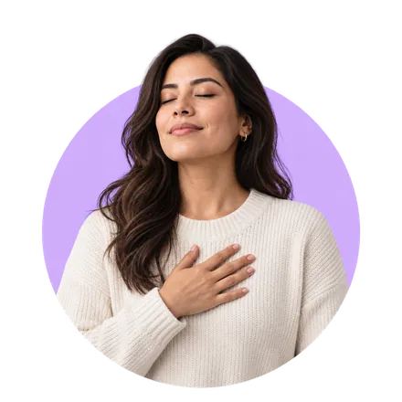 A woman breathing deeply with her hand on her chest